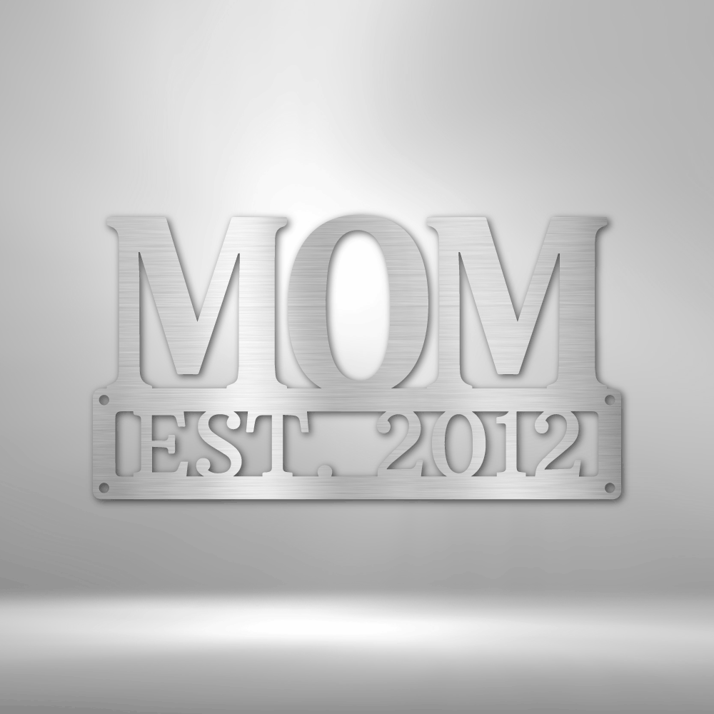 A PERSONALIZED Mother's Day Plaque - Unique Metal Art Gift that says mom est 1954 hanging on a brick wall.