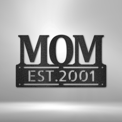 A UNIQUE Metal Wall Art Decor - Personalized Mother's Day Plaque with the word mom, hanging on a brick wall.