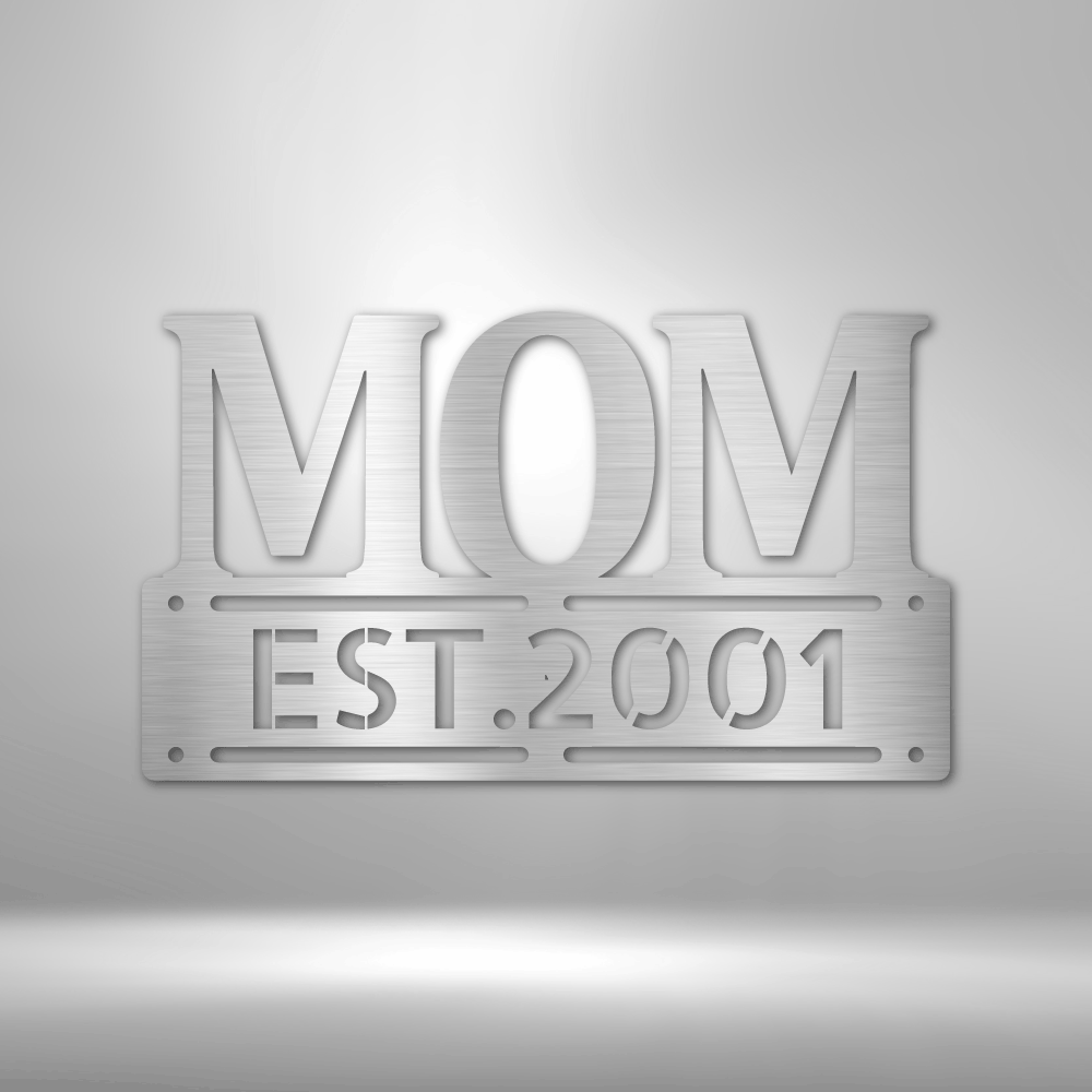 A UNIQUE Metal Wall Art Decor - Personalized Mother's Day Plaque with the word mom, hanging on a brick wall.