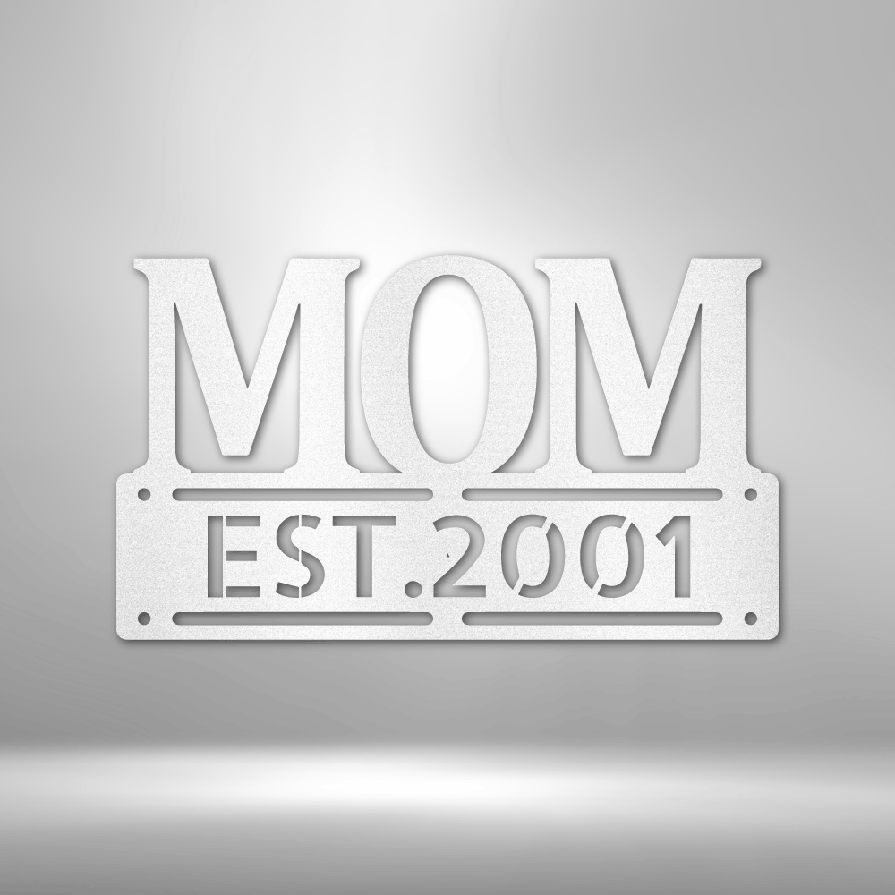 A UNIQUE Metal Wall Art Decor - Personalized Mother's Day Plaque with the word mom, hanging on a brick wall.