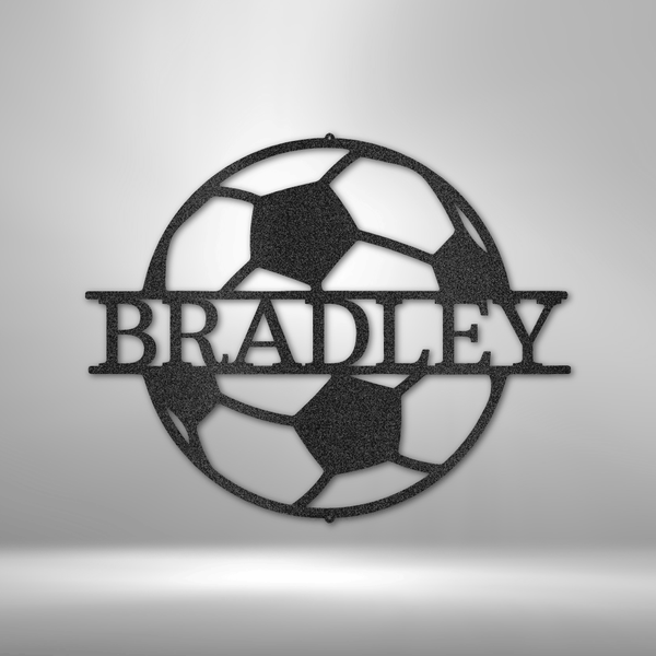 A durable soccer monogram metal sign with the name Bradley on a brick wall.