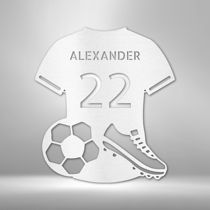 A durable outdoor metal sign featuring a custom handmade design of a soccer jersey monogram with the name Alexander 22 personalized on it.