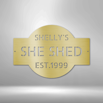 A PERSONALIZED Metal Wall Art Decor plaque that says she shed on a brick wall.