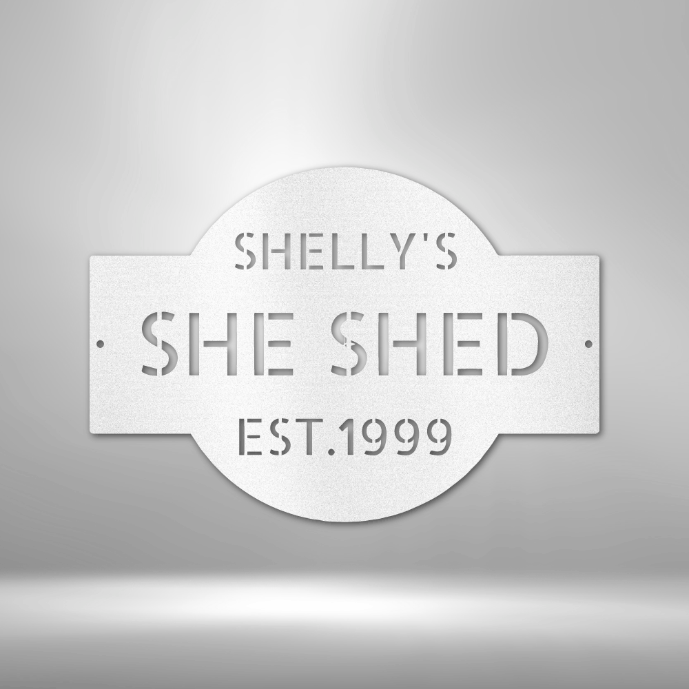 A PERSONALIZED Metal Wall Art Decor plaque that says she shed on a brick wall.