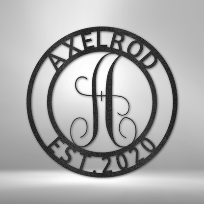 A custom handmade steel monogram sign with the personalized family name on it.