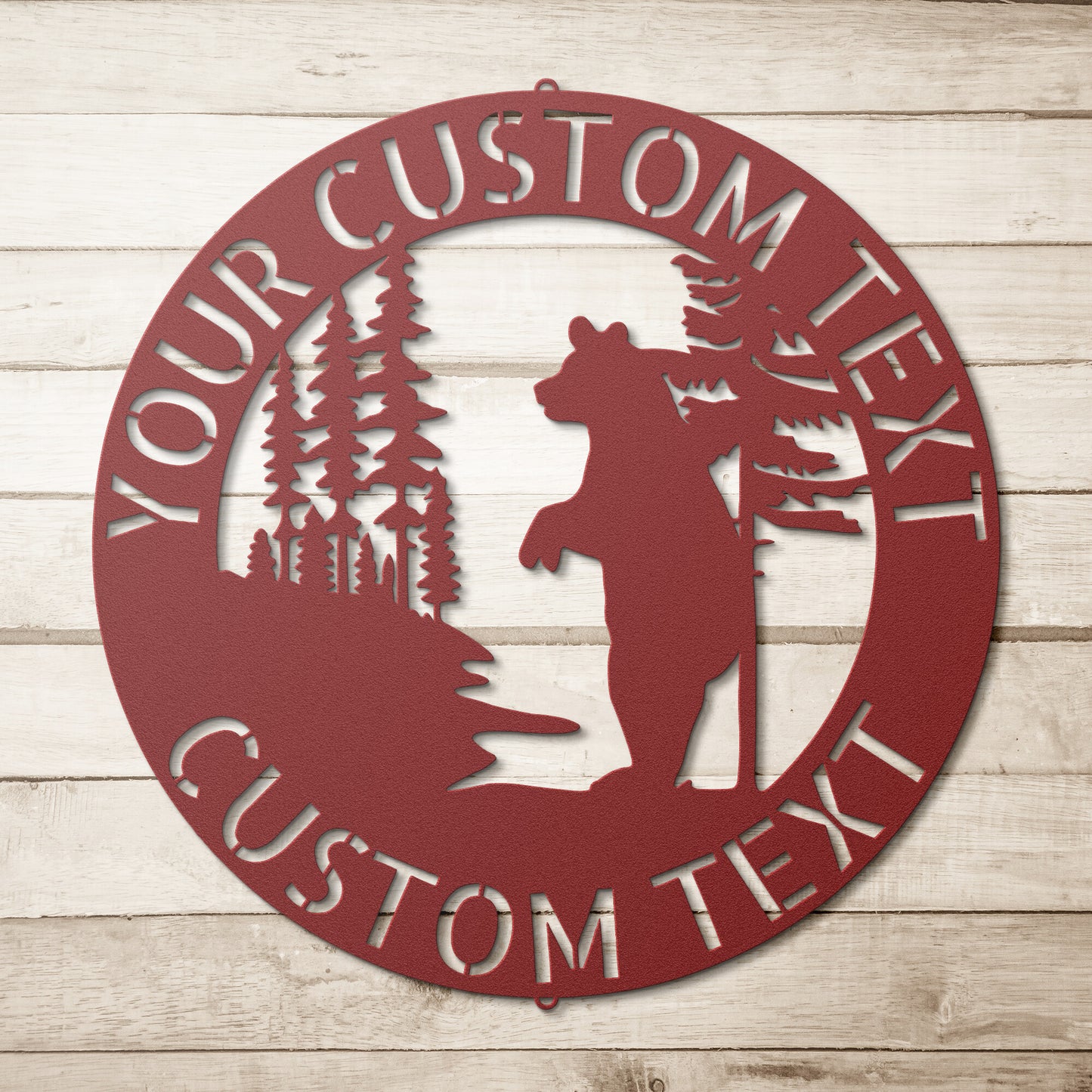 A black BEAR METAL SIGN - Customized Bear Established Steel Monogram Wall Sign on a wood surface, creating Personalized Family Signs.