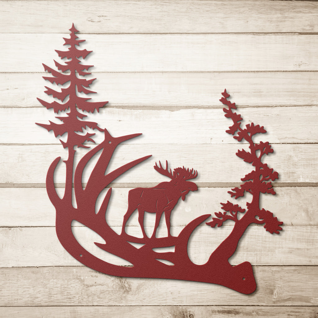 Red Moose's Horn Steel Monogram Wall Art Home Decor with pine trees on a wooden background, featuring personalized steel monogram and custom handmade designs.
