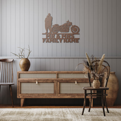 A personalized metal family wall art featuring a silhouette of a Mr&Mrs Harley-Davidson couple SET 13 on a brick wall.