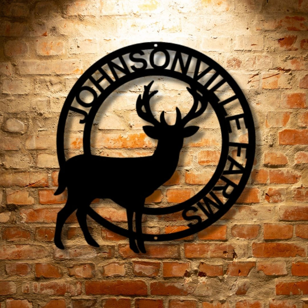 A custom metal wall art decor featuring a stag monogram design on a steel sign in front of a brick wall.