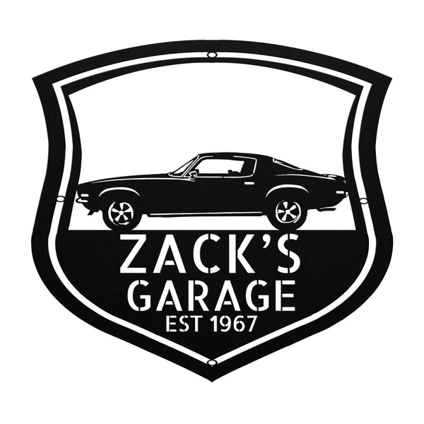 A Vintage Car Monogram Sign with Custom Car Steel Sign features, hanging on a brick wall, makes for a classic addition to any workshop or garage.