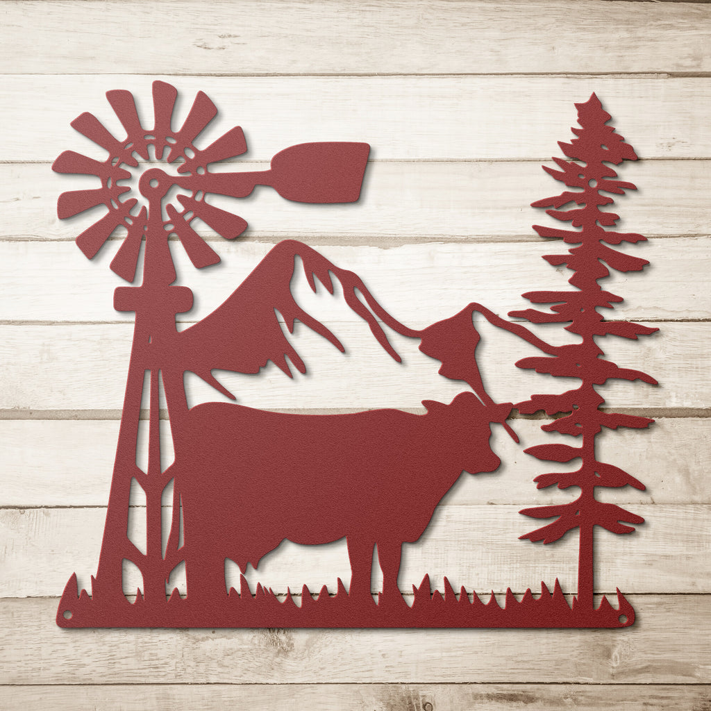 A Durable Outdoor Metal Sign with a Steel Monogram Design featuring a Cattle and Trees on a Wooden Background.