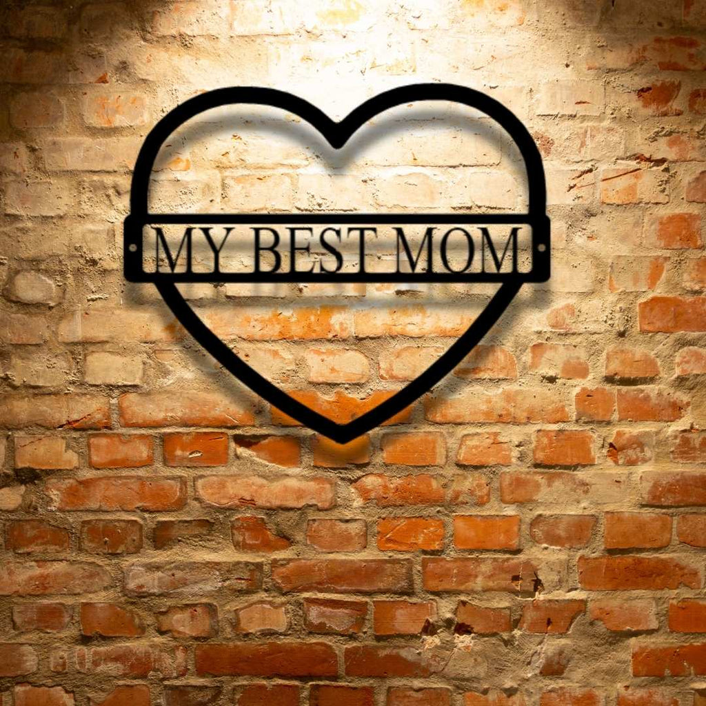 A personalized steel monogram that says "my best mom" on a brick wall.