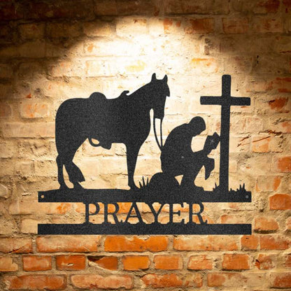 Unique Metal Art Gifts, personalized Family Signs featuring a silhouette of a Kneeling Cowboy Monogram - Steel Sign praying in front of a brick wall.